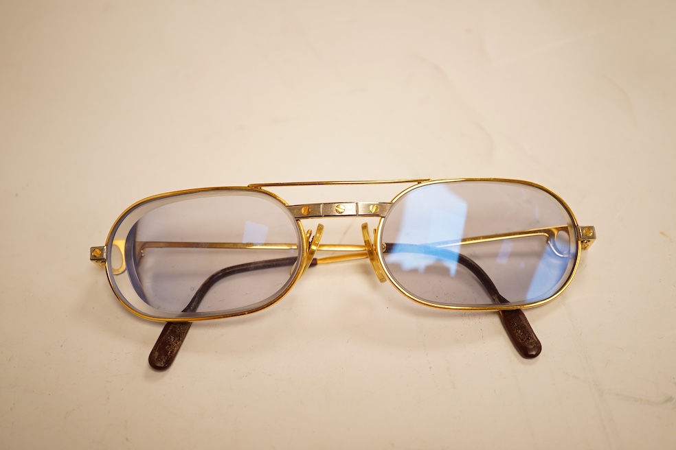 Two pairs of vintage Cartier gilt metal glasses, a pair of Gucci glasses and another